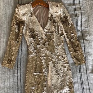 Sequined dress with deep v, and shoulder pads.